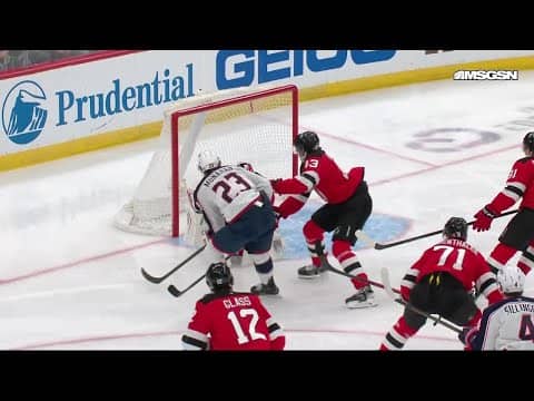 Sean Monahan scores a goal against the New Jersey Devils