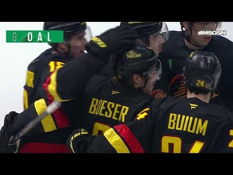Brock Boeser scores a goal against the New Jersey Devils