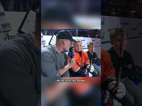 Joe Buck interviews sons during intermission at a Blues game