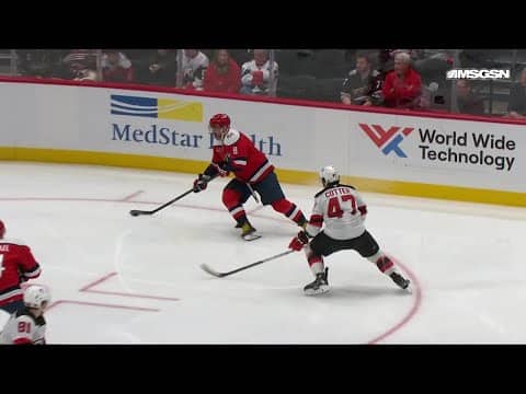 Connor McMichael scores a goal against the New Jersey Devils