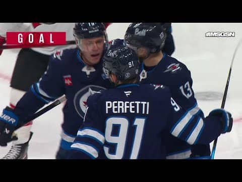 Jonathan Toews scores a goal against the New Jersey Devils