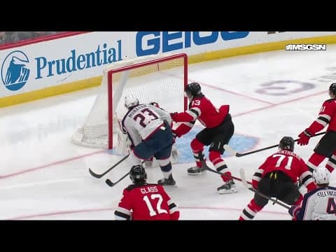 Sean Monahan scores a goal against the New Jersey Devils