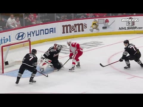 Alex DeBrincat scores a goal against the New Jersey Devils