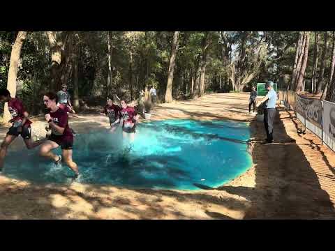 Runners run through water pit the day before the 2026 World Cross Country Championships.