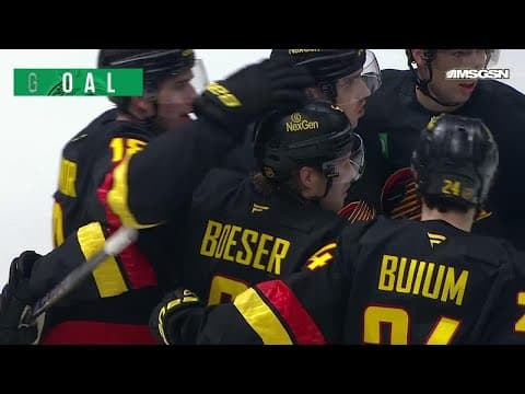 Brock Boeser scores a goal against the New Jersey Devils