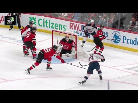 Sean Monahan scores a goal against the New Jersey Devils